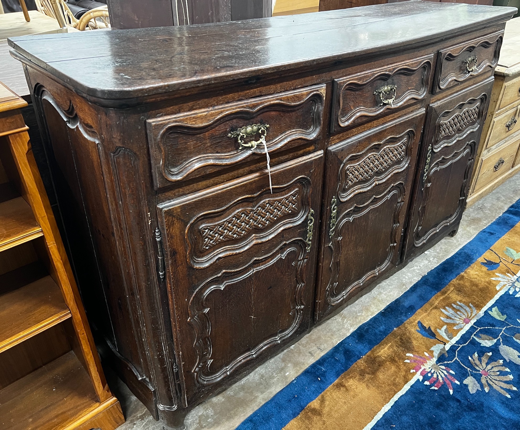 An 18th century French Provincial oak buffet, lacking two feet, width 171cm depth 48cm height 110cm